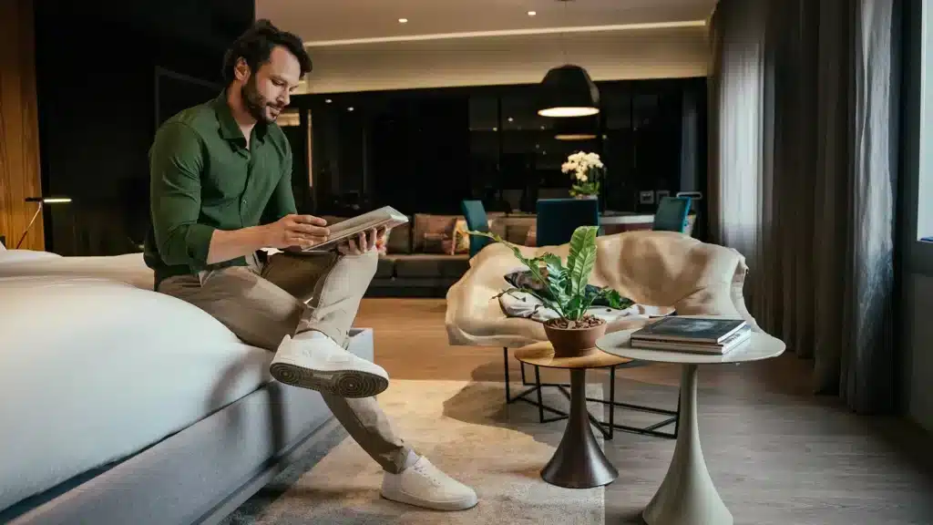 Guest sits in a cozy lobby and reads a magazine